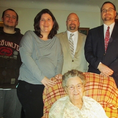 Mom on Christmas Eve (2013) with 'in-laws' (Freddie, Melissa, Greg and Dan) standing behind.
