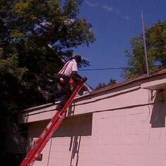 Bishop Edwards working on the church roof