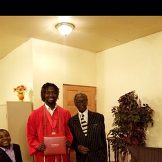 My oldest son Justin Graduation picture with our pastor and jr.
