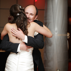 Hugging daughter on wedding day