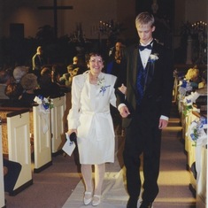 Jeff's youngest son, Mark, ushers his Grandma up the aisle.