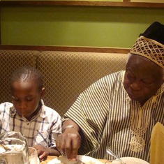 Temi with Granddad enjoying a restaurant meal.
