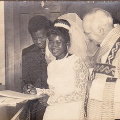 Daddy and Mummy signing the marriage register in London in the sixties