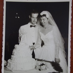 Bill and Pat cutting their wedding cake, July 20, 1957
