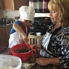 Patricia baking molasses cookies with her grandson, Liam