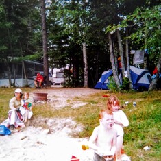 Aunt Pat camping on the beach holding daughter Julie son Luke in the back & nephewGabe& Niece Sierra