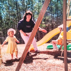 Aunt Pat paying on the swings with daughter Julie and niece Sierra