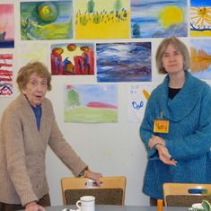 Pat and her friend at Elderwise, December 2013. The paintings on the wall behind them were all done by Elderwise participants.