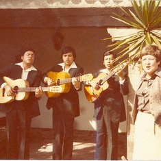 Mom singing with dressed-down Mariachis