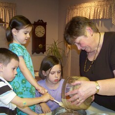 Aunt Pat making cake with her Grand nieces and nephew. 