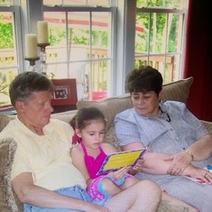 Grand Niece Caroline reading to Aunt Pat and Uncle Bob