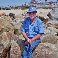 Grandpop on the beach in San Diego CA. This is my favorite picture of Grandpop. This is how I will remember him. The piece of drift wood he is holding in his hand he later sent to us with an inscription about the time we spent on the beach with him.