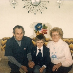 Paul and Grandpa and Grandma Svik celebrating his First Communion.