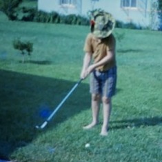 Don wearing "Jungle Jim" Commando hat from Paul and trying to hit a golf ball