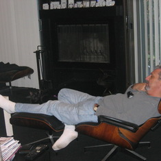 Dad in the Eames chair with Jerry on his legs (she's black and blends in)