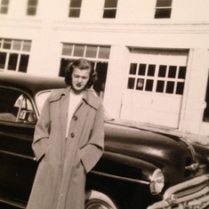 Mom next to one of the hot cars of her time...