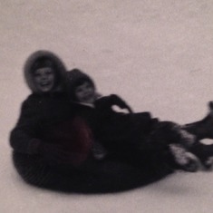 Jojo and Deanna riding intertube down a hill in lake Tahoe, Christmas vacation with family