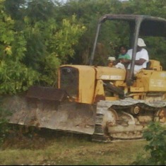 Percy & Shunny (grandson) on his dozer in his back yard.