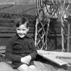 1941 - Peter sitting on top of the Anderson air-raid shelter in the back yard at 62 Grove Avenue in Twickenham.