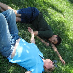 Lying around on the grass. 