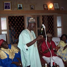 Bambot looks on as Pa Kangkolo pops a champagne to celebrate the wedding of Ni Jude and Ma Lilian at the family home in Njimafor. Dec 2005