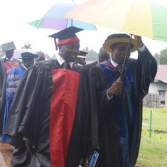 Prof. Ojiambo shilelding his friend when it rained heavily during graduation day.