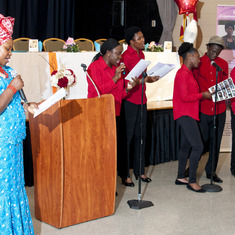 Mrs. Adijatu Aliu Kenneth-Unuovurhaye leads the hymn while the Peculiar Family Worship Center Choir sings along with her