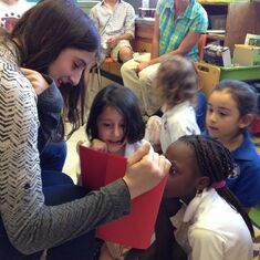 Rachel reading French stories to children at IST