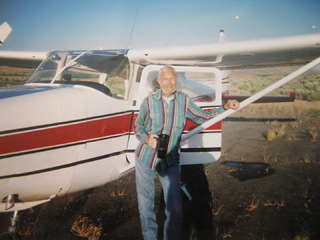 Ralph standing infront of his son Bill's airplane. He loved to fly