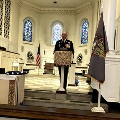 Chaplain speaking at Ray's service in Old Post Chapel