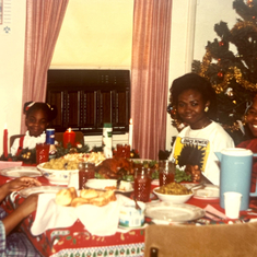 Mama sharing Christmas meal with her daughters, Anuli and Uche and grandchildren
