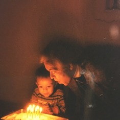 Jim blowing out candles with grandson Eric
