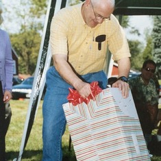 Jim opening his gift from the Tappan Reformed Church when he retired.