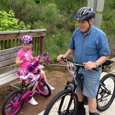 Grandpa and granddaughter enjoying a bike ride