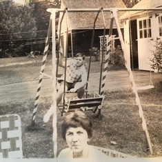 Looking cool on  our old swingset on Ferris Ave in Utica. Grandma in the foreground.