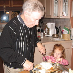 Em is learning how to carve a turkey. Granddad has been doing it for years!
