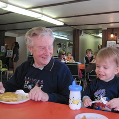 Granddad and Allan are enjoying pancakes and fresh maple syrup.