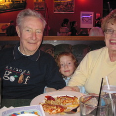 The best place for a granddaughter is between her grandparents, eating pizza.