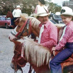 Robert and Amy ride horses in the State Fair of Texas parade