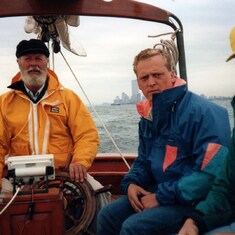 1991 - leaving NYC from the Mayor's Cup en route to Norfolk, VA. Captain Bob, Peter Brown, Clif Seifert. WTC and Statue of Liberty in the background.