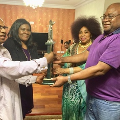 Out-going President, Dr Boma Douglas & wife June Douglas hand over the Club’s trophy to Bob & his wife, Rose (new 1st Lady).