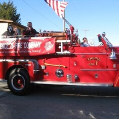 Dad Me Christian and Lacey on The 60 Seagrave Firetruck in the Independence Missouri Halloween Parade