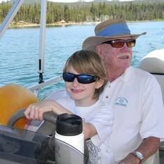 Letting grandson, Ben, take the wheel while boating on Elk Lake