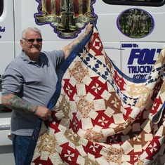 Bob showing the Quilt of Valor presented to him for serving our country.
