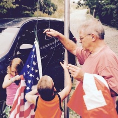 Teaching the great grandkids how to put up the flag making sure to not let it touch the ground. 