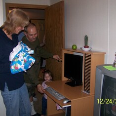 Dad showing mom her new computer and desk that she got for christmas