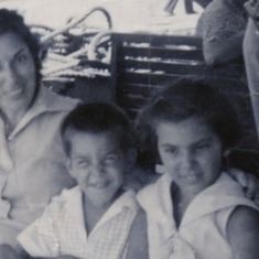Ro, on a boat in Japan, with her favorite brother and her mother.