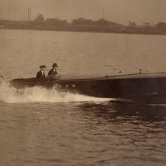 Rosemary's father, Justin Rice Whiting at the helm of a recreational motorboat. Yacht ensign flag identifies this.   Picture was framed, dirty, in garage of Rosemary's house; probably used to hang in parent's house in Camarillo, CA.