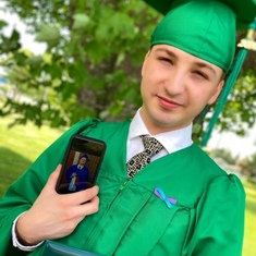Lucas on Graduation day holding his phone with a pic of Roy on his Graduation day :)