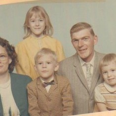 one of the first family photo's Tracey standing, in the back in yellow, Roy jr in the bow tie, Pam sitting on Roy's lap,